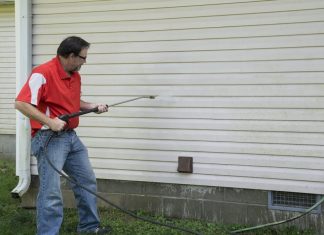 man using a pressure washer
